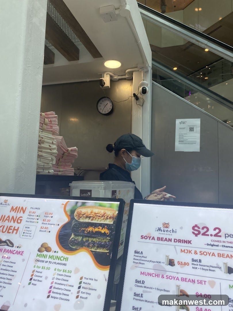 Food stall interior with menu boards and staff