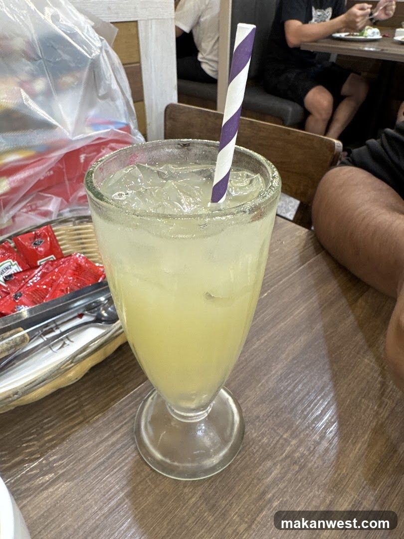 Yellow Iced Drink with Striped Straw