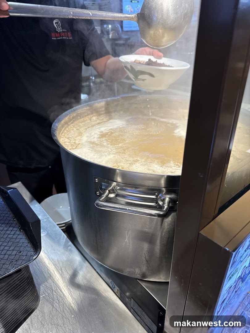 Chef serving soup from large pot