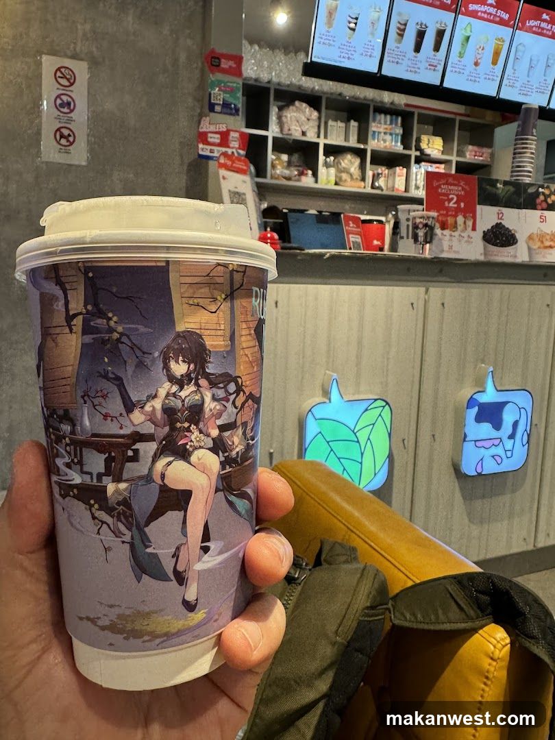 Anime-themed drink cup in a cafe interior