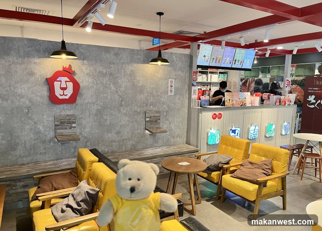 Interior of a cafe with yellow armchairs and a bear mascot