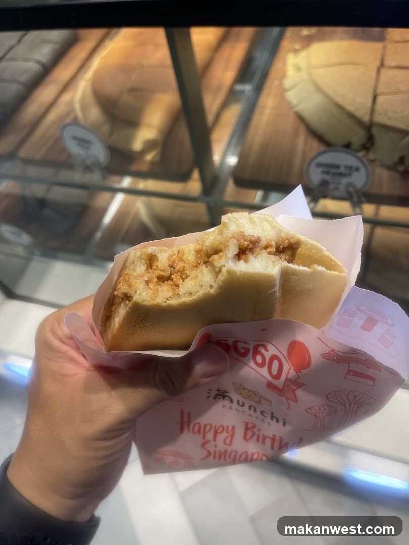 Hand holding pancake sandwich