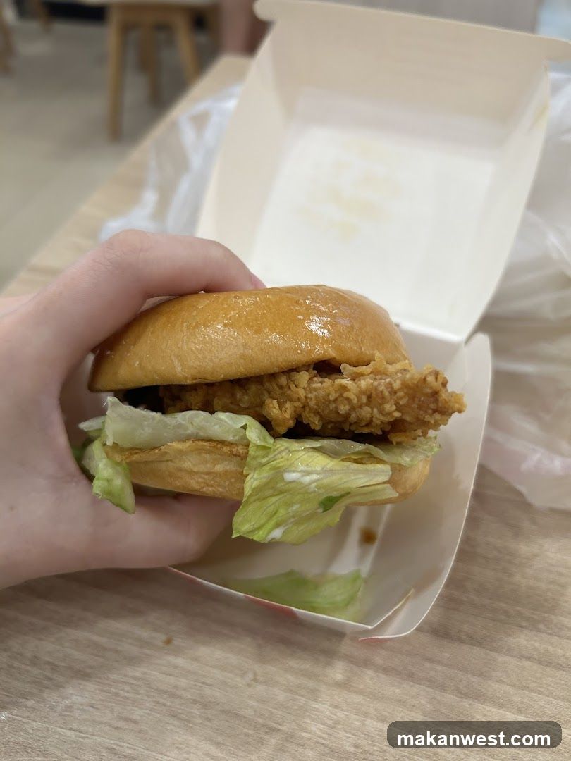 Hand Holding Fried Chicken Sandwich