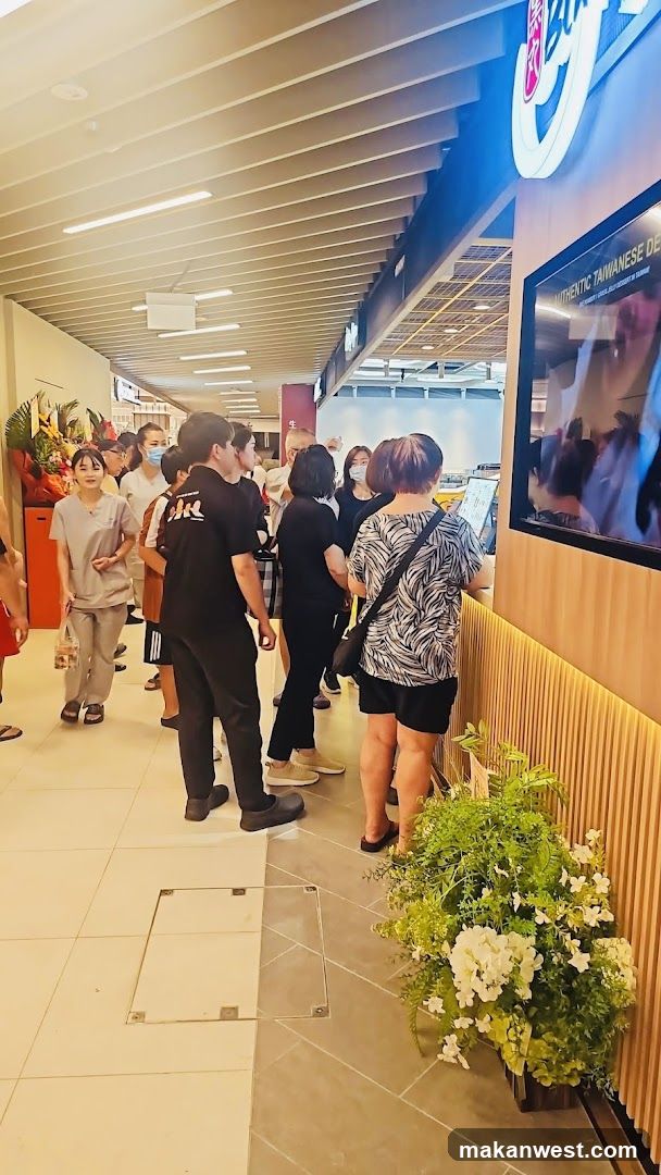 Crowded Interior Space with Digital Screen and Plants