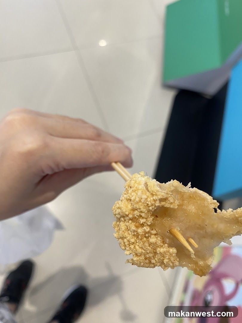 Hand holding skewered food item