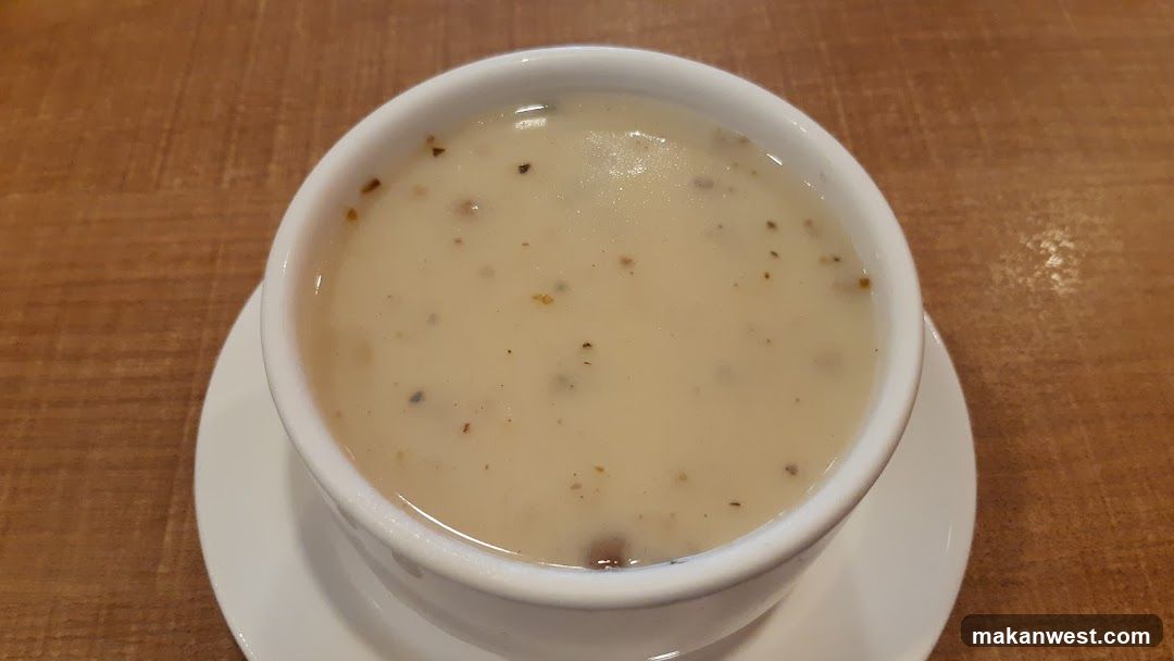 Bowl of creamy soup with visible specks