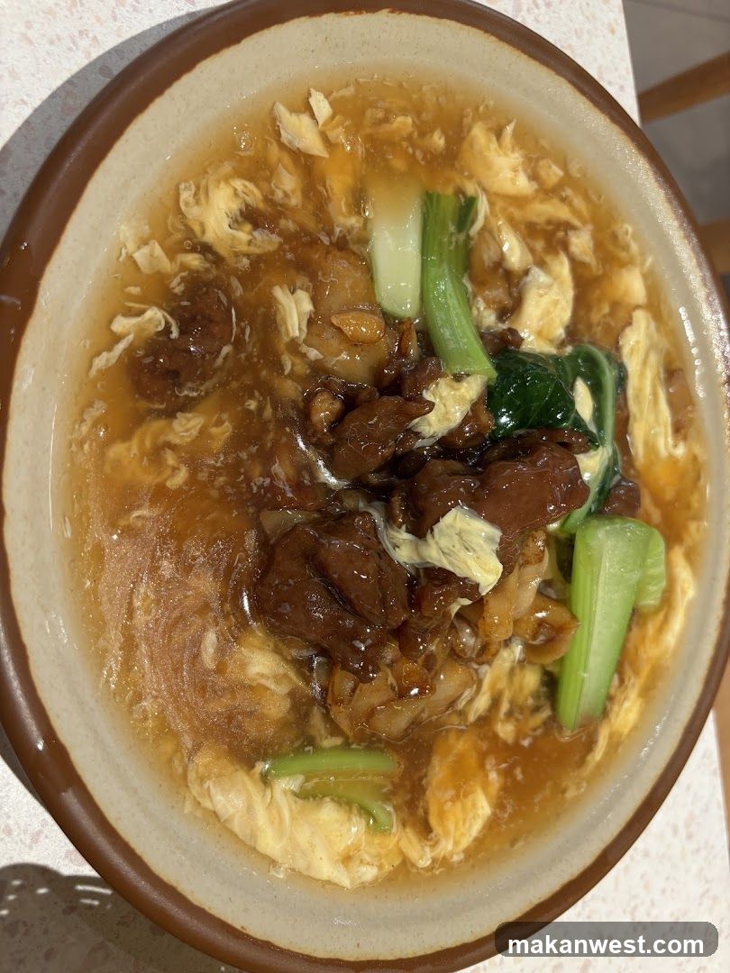 Bowl of Egg Drop Soup with Meat and Greens