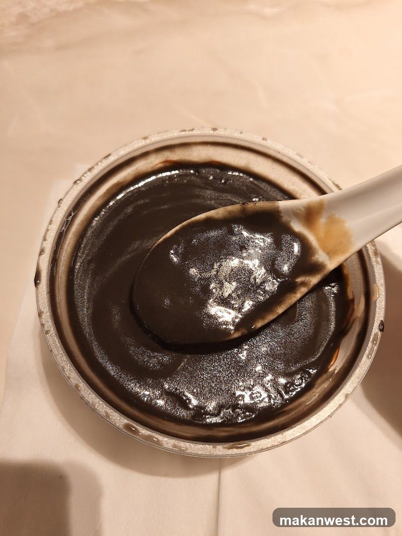 Bowl of Dark Paste with Spoon