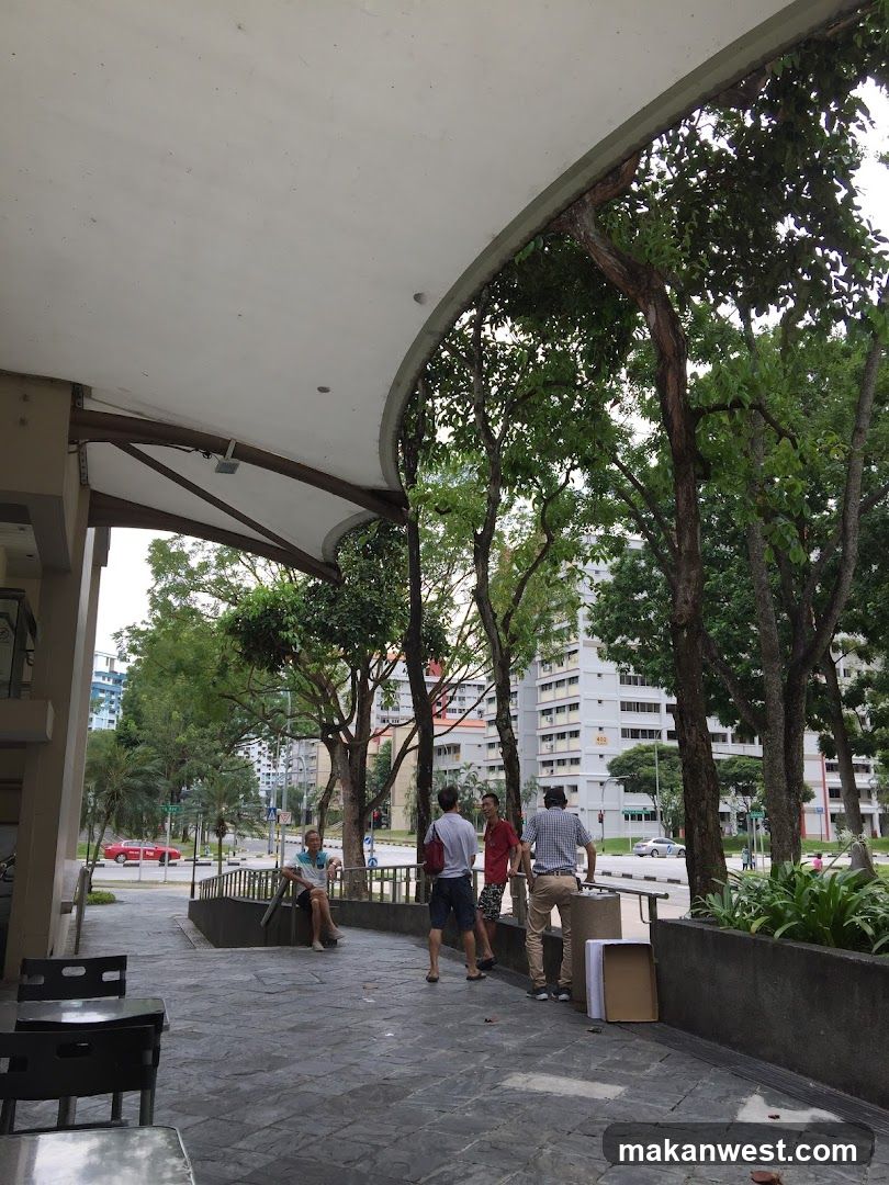 Outdoor seating area with people and boxes