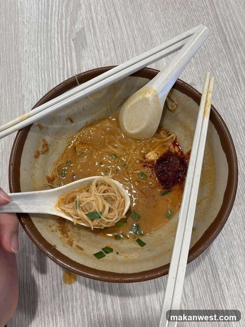 Bowl of Noodles with Chopsticks and Spoon