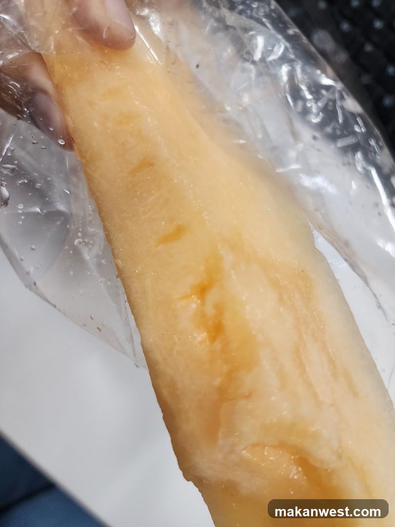 Hand holding a wrapped food item