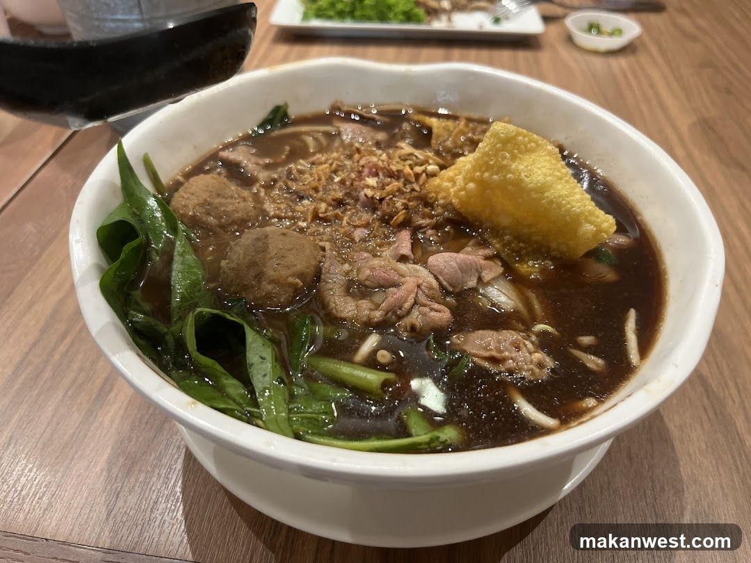 Bowl of Noodle Soup with Meatballs and Greens