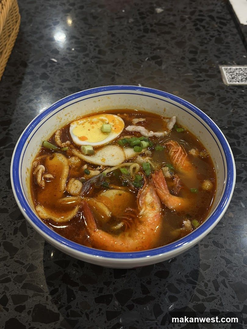 Bowl of Spicy Noodle Soup with Shrimp and Egg