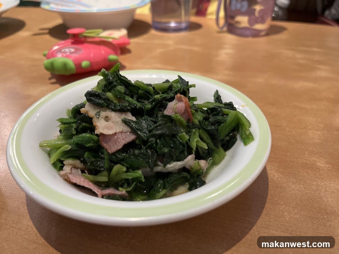 Stir-fried greens with meat on a plate