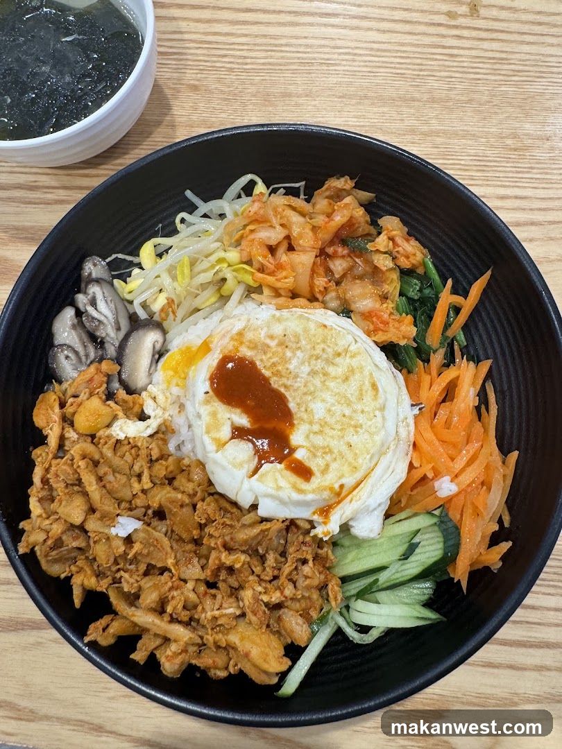 Bowl of Bibimbap with Fried Egg and Side Dishes