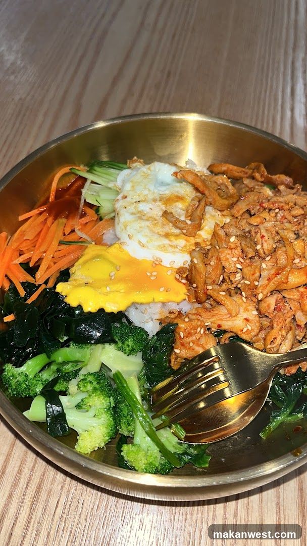 Bowl of Korean-style Bibimbap with Fried Egg and Broccoli