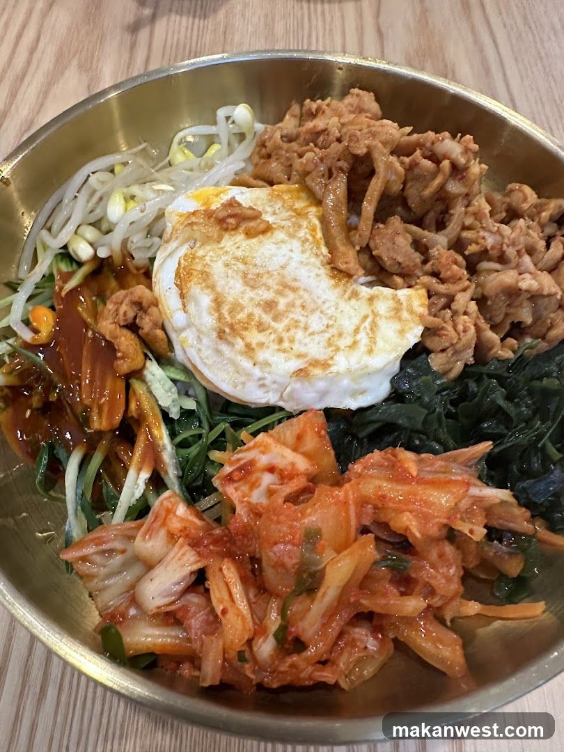 Bowl of Korean-style Bibimbap with Fried Egg and Kimchi