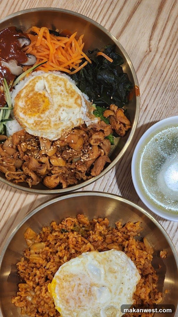 Bowl of Korean-style rice dishes with fried egg and side vegetables