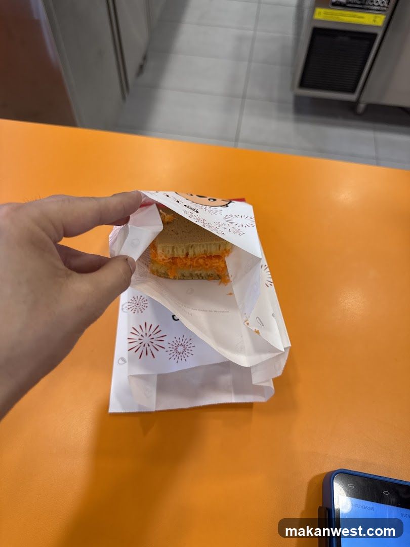 Sandwich in Wrapper on Orange Table