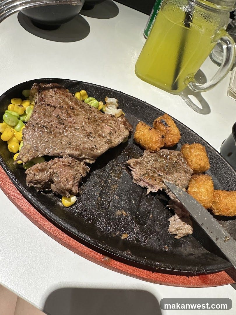 Sizzling Steak Plate with Corn and Tater Tots