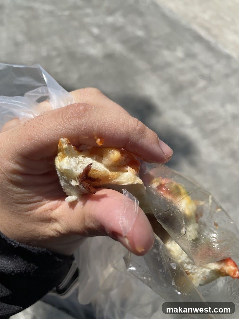 Hand holding food in plastic bag