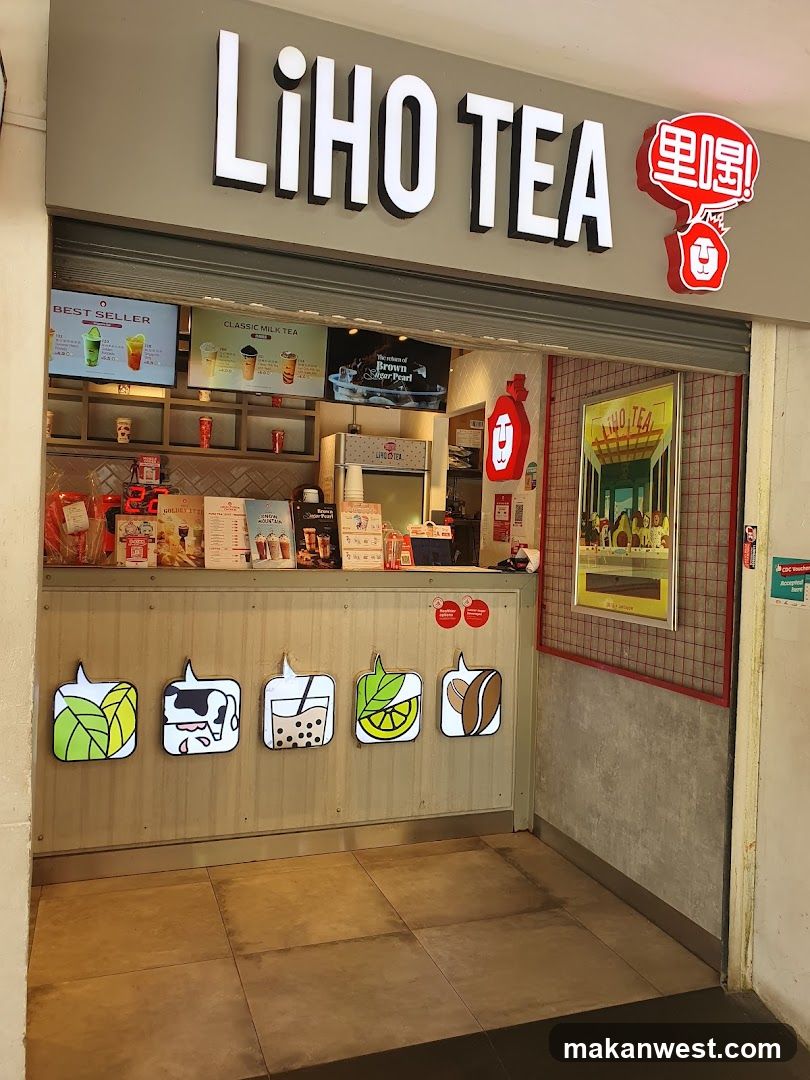A Liho Tea shop entrance with visible signage, menu boards inside, and decorative fruit cutouts on the counter.