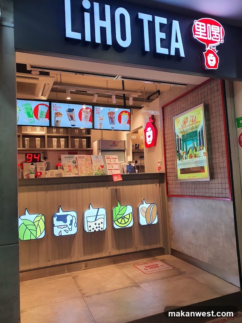 A Liho Tea shop with illuminated signage and a menu board displaying various drink options.