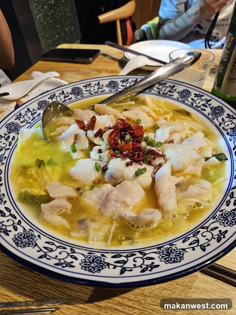 Bowl of Fish Soup with Chili Oil and Scallions