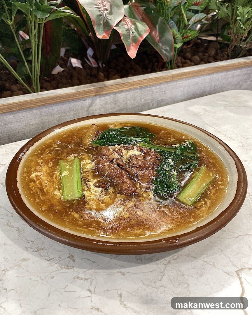 Bowl of Noodle Soup with Meat and Greens