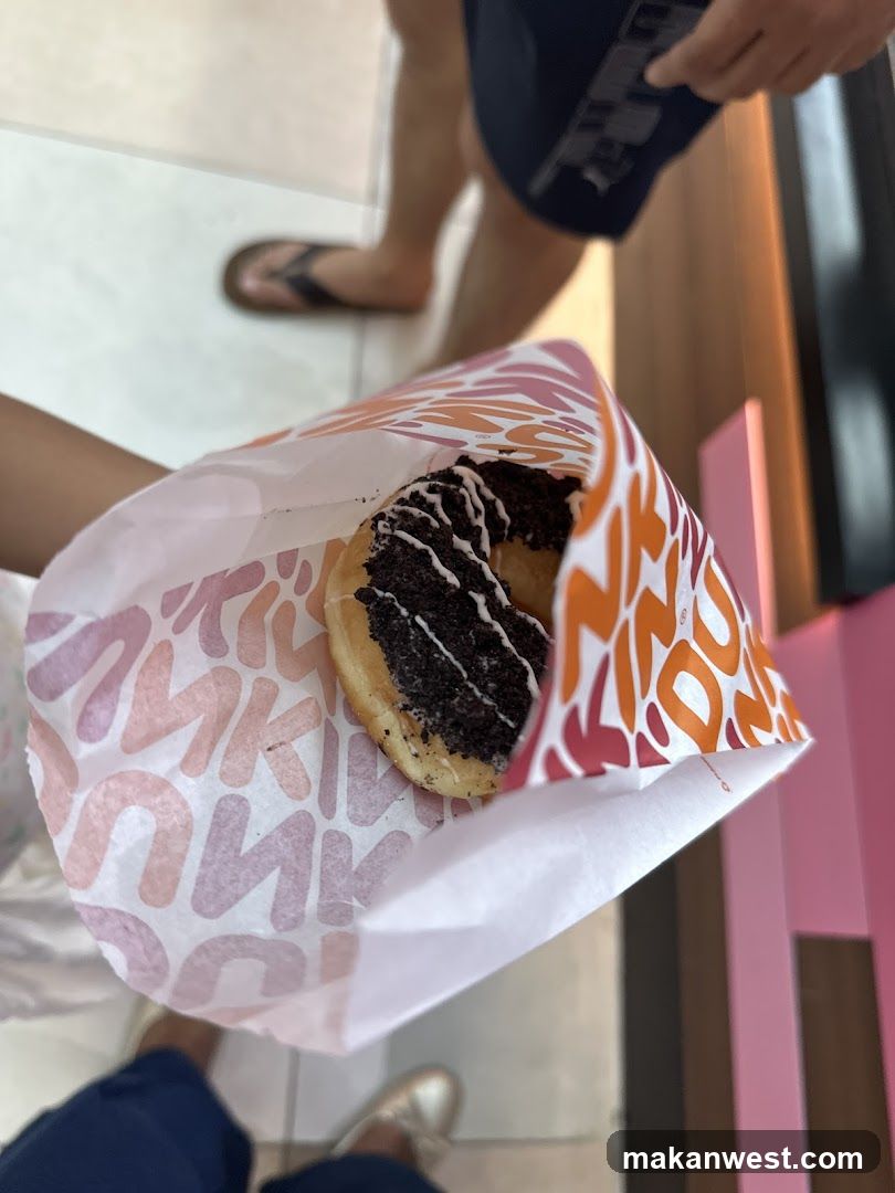 Dunkin Donuts pastry in branded paper bag