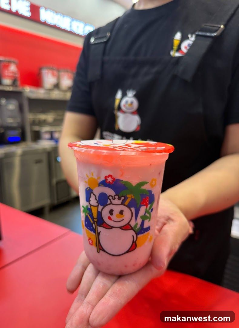 Staff holding a pink drink cup