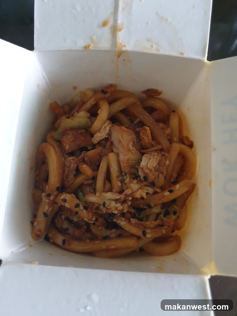 Takeout food container with noodles and meat