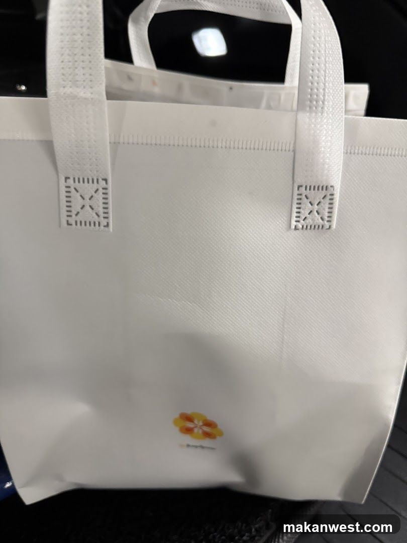 White tote bag with floral logo