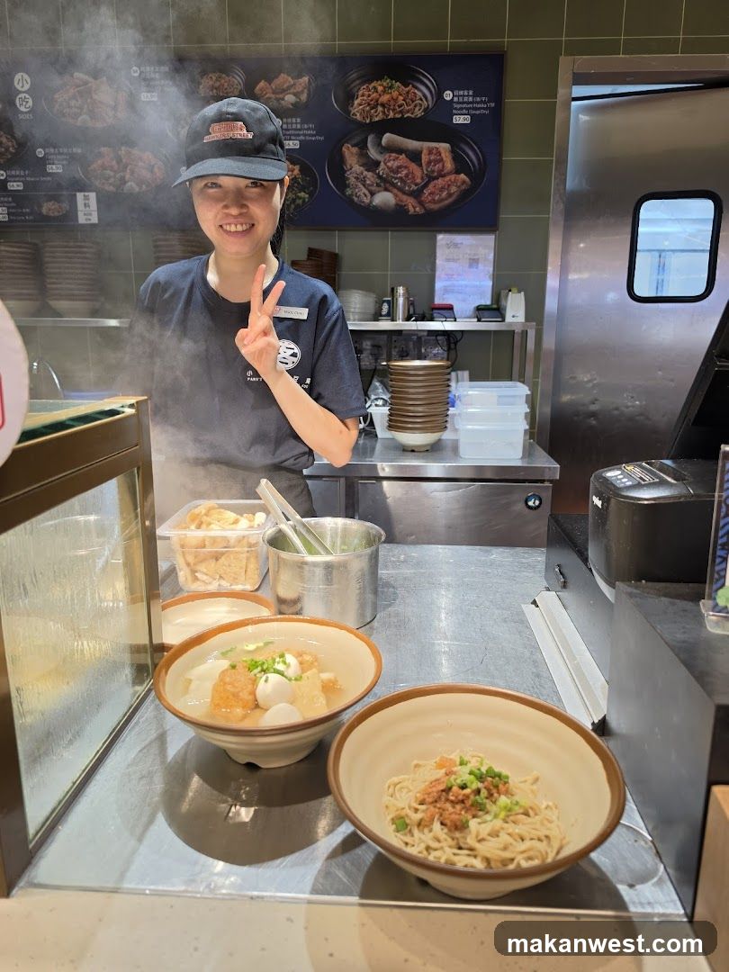 Staff with prepared noodle dishes