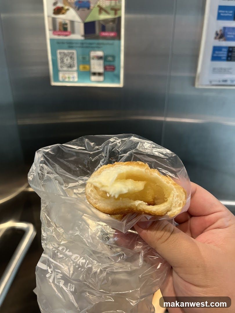 Hand holding pastry in plastic bag