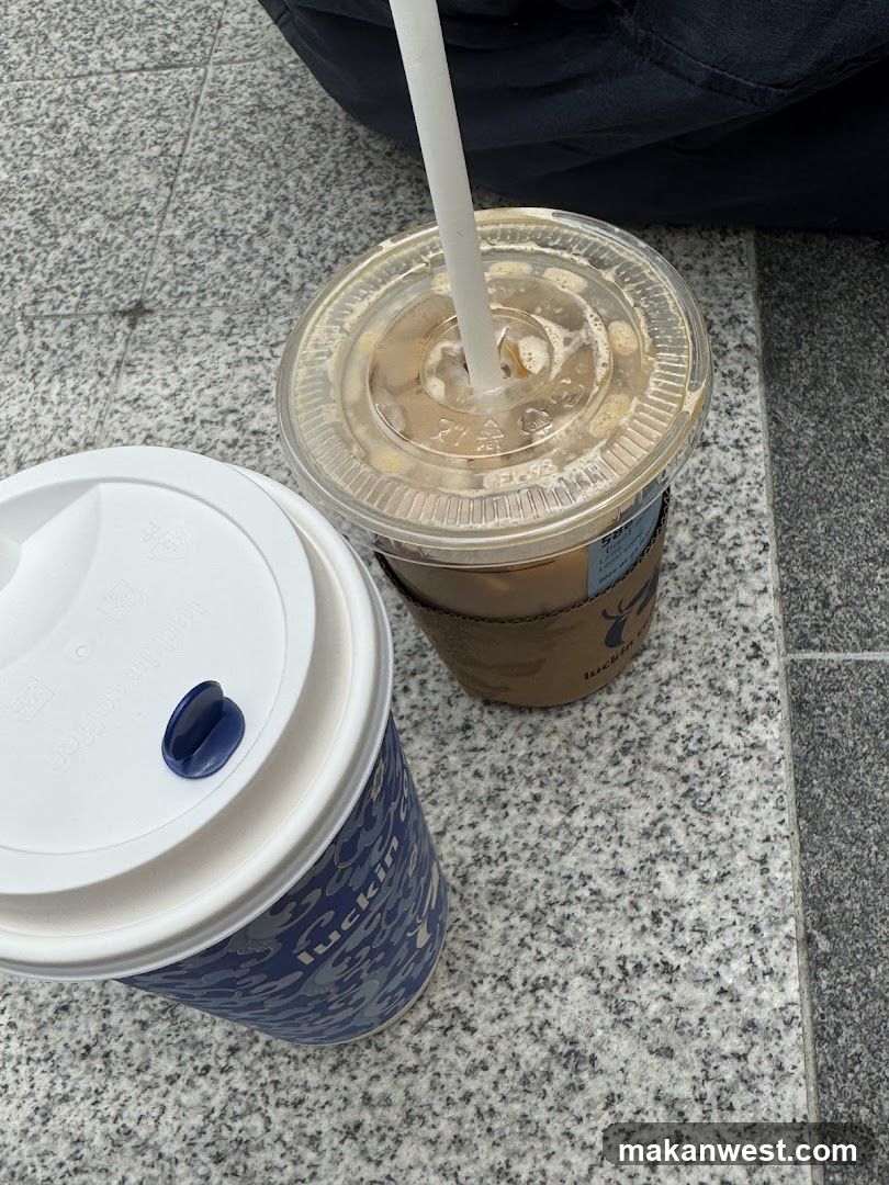 Two coffee cups on pavement