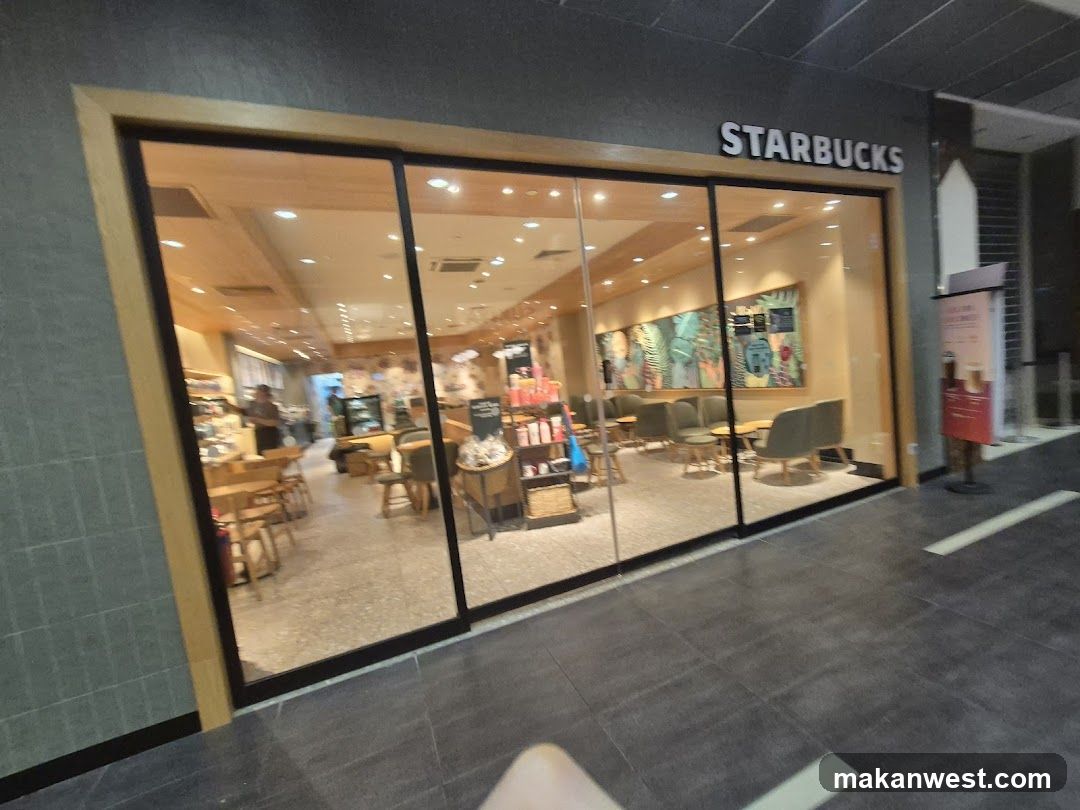 A Starbucks store with large glass windows and doors, displaying interior seating areas and colorful wall art.