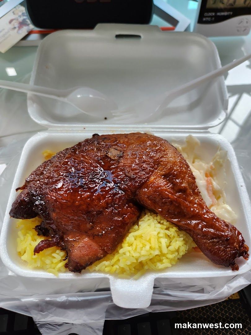 Takeout Meal with Glazed Chicken Leg and Yellow Rice