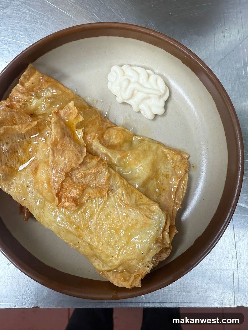 Folded pastry with sauce and dollop on plate