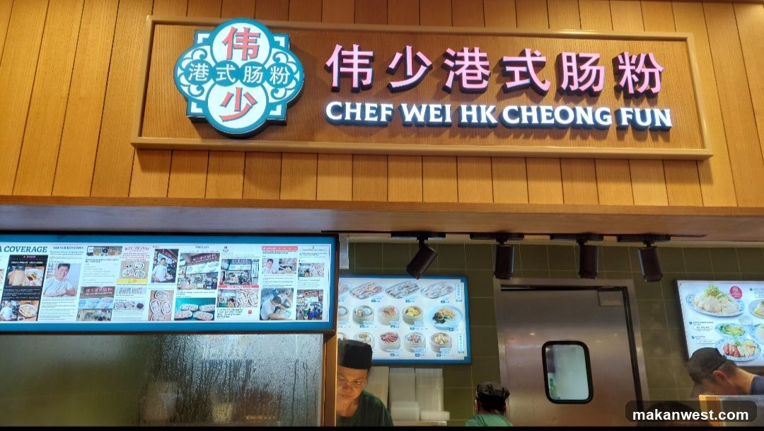 The image shows the storefront of a restaurant named 'Chef Wei HK Cheong Fun'. The signboard features Chinese characters and English text, with a logo on the left side displaying 'Wei' and 'Cheong Fun'. Below the main sign, there are menu boards visible through glass windows, showcasing various food items. Staff members can be seen inside the shop.