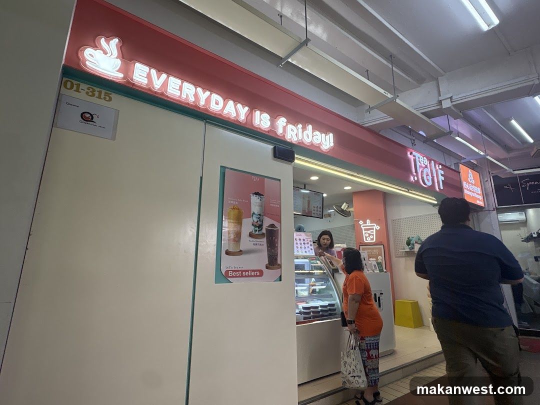 Storefront with illuminated sign reading 'EVERYDAY IS FRIDAY!' and a poster showing three drink options labeled 'Best sellers'. A person in orange shirt stands near the entrance, another customer walks by.