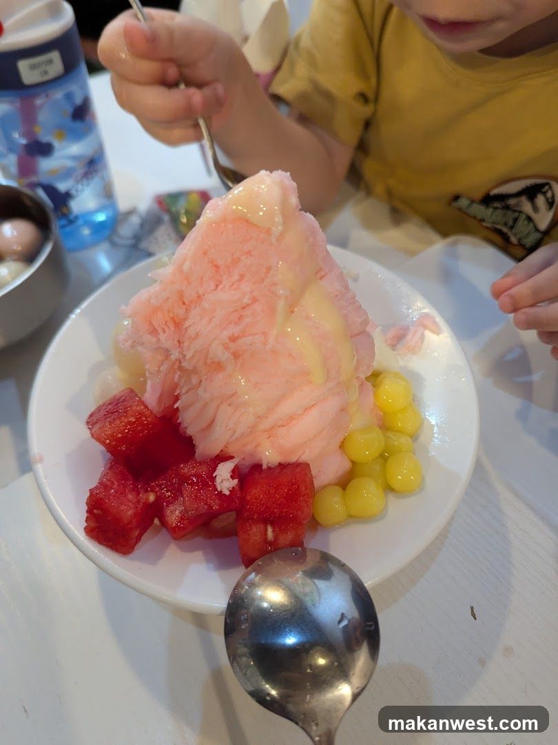 Child Eating Dessert with Fruit and Syrup