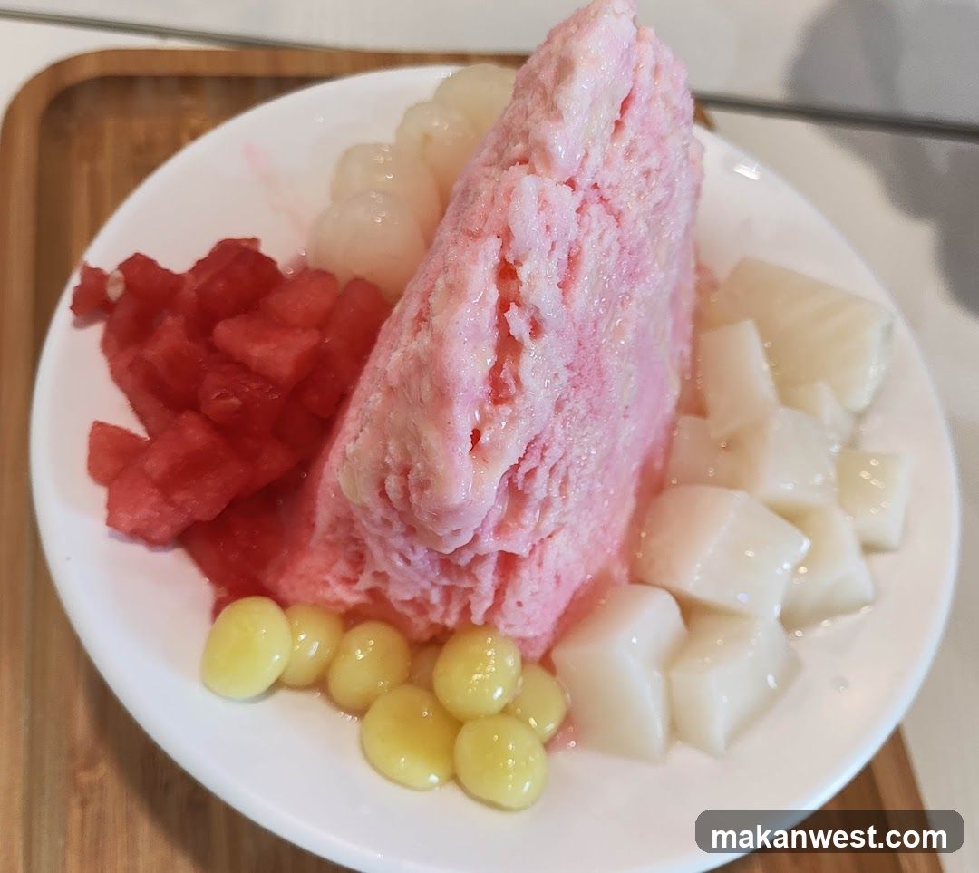Pink shaved ice dessert with fruit toppings