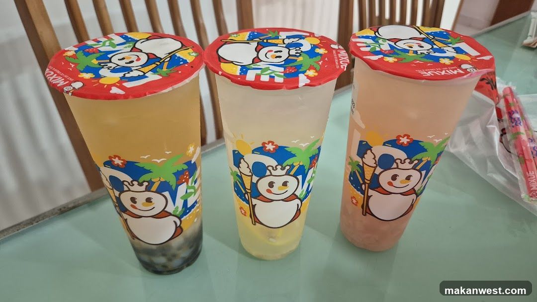 Three colorful bubble tea cups on a table