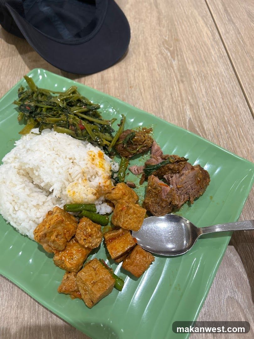 Plate of Thai-style food with rice and vegetables