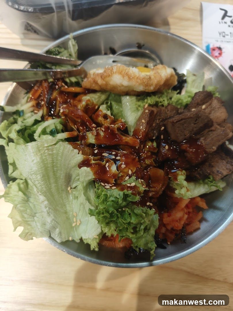 Bowl of Korean-style Bibimbap with Fried Egg and Sauce