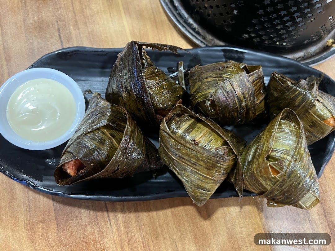 Bamboo-wrapped dumplings with dipping sauce
