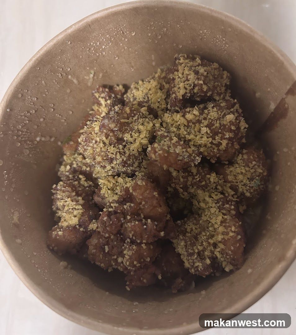 Bowl of breaded food with green garnish