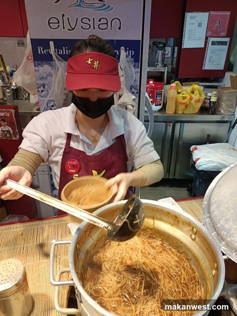 Staff preparing noodles at a food stall