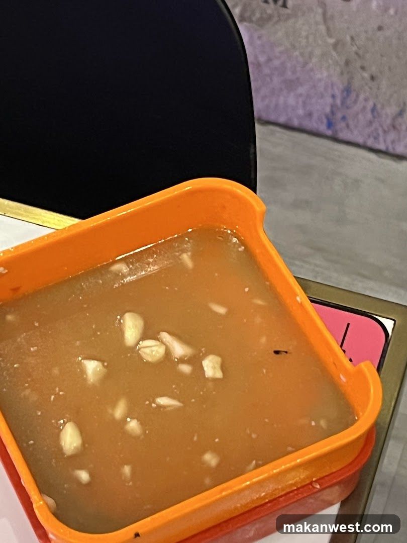 Bowl of soup with garlic pieces in an orange container